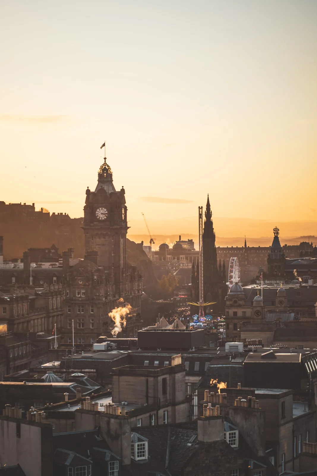 Orange evening light over Edinburgh buildings from Calton Hill